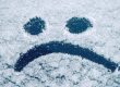 Sad smiley emoticon face drawn on snow covered glass winter season sadness concept