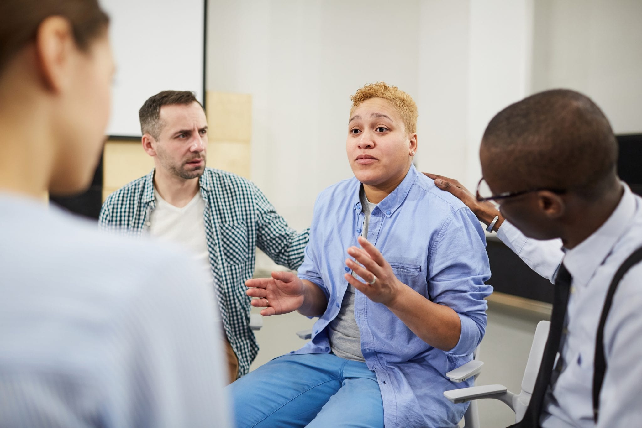 Mixed race woman in group therapy setting