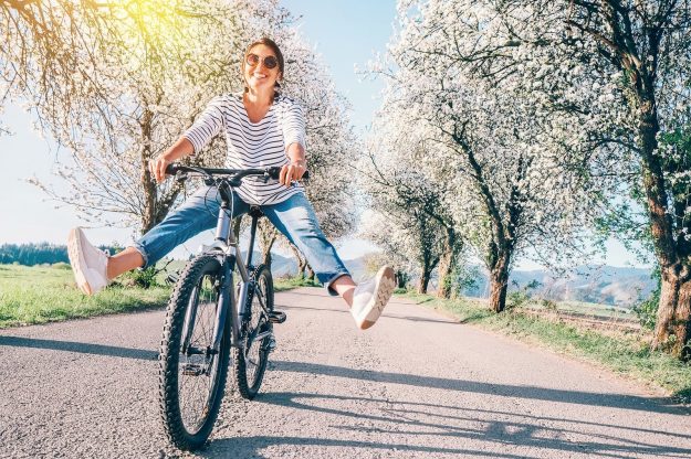 Happy Smiling Woman Riding a Bike