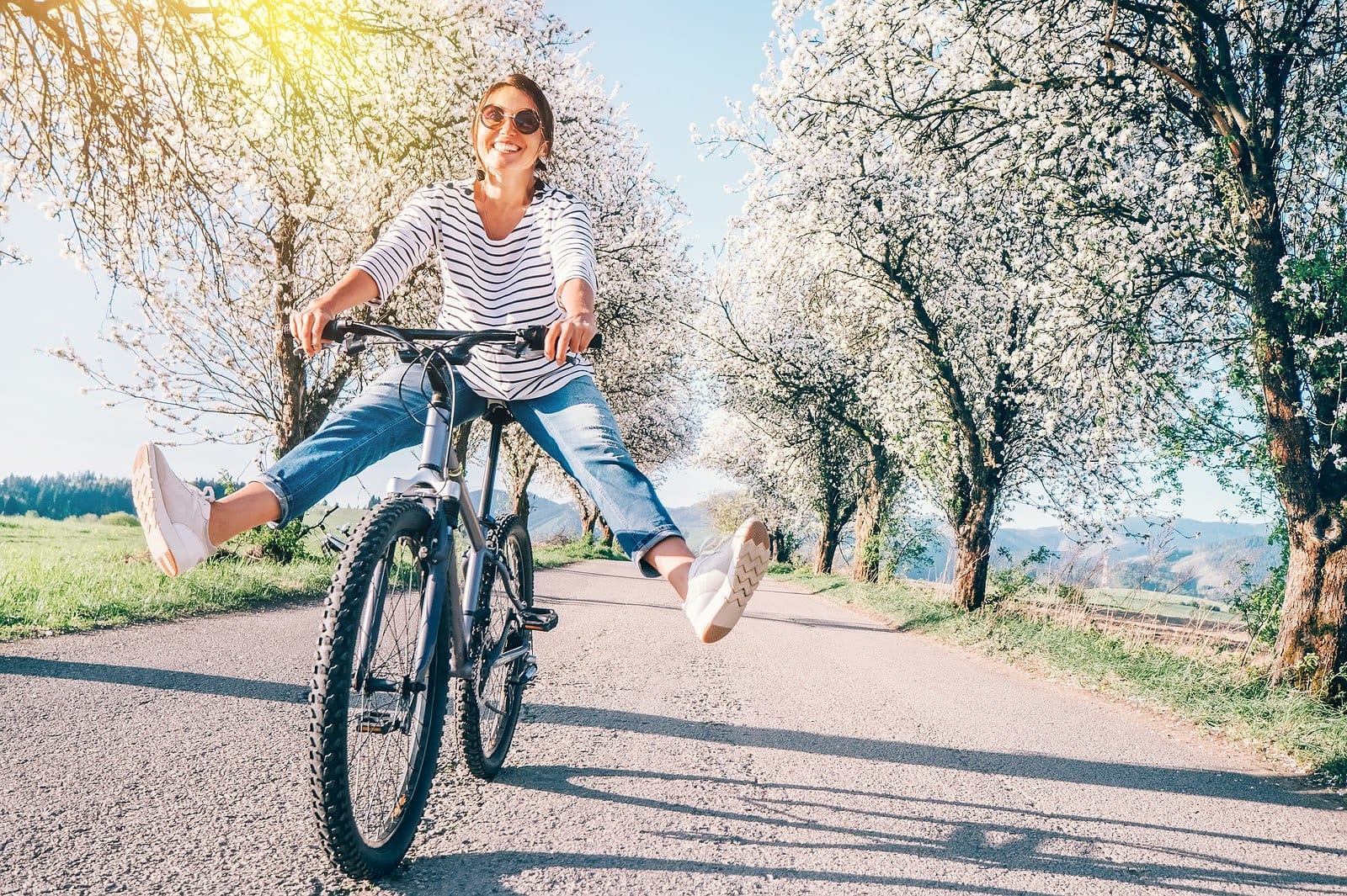 Happy Smiling Woman Riding a Bike