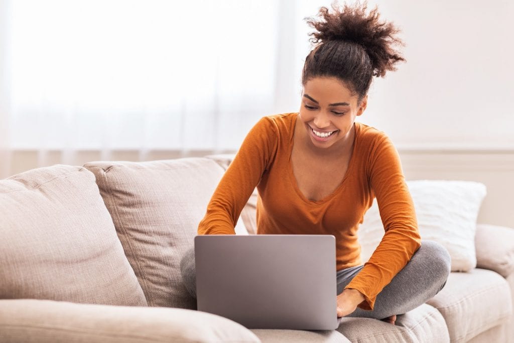 Smiling woman using a laptop