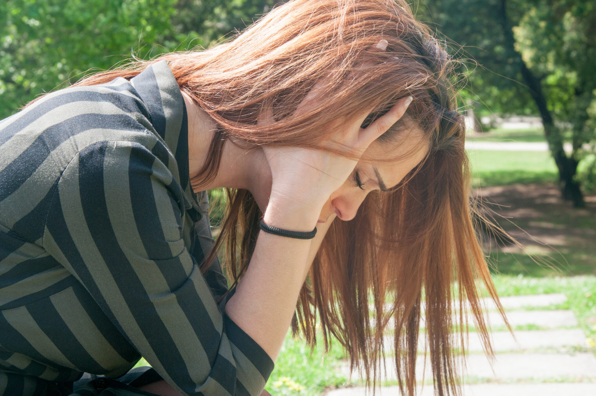 Young woman struggling with seasonal depression in summer