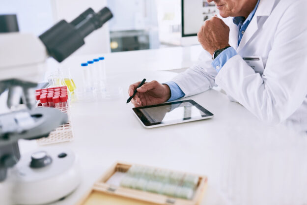 hands-tablet-science-with-person-laboratory-desk-breakthrough-innovation-research-discovery-pharmaceuticals-technology-with-scientist-work-clinical-trial-experiment